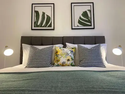 a bedroom with a bed with three pictures on the wall at Womack Lodge in Saint Helens