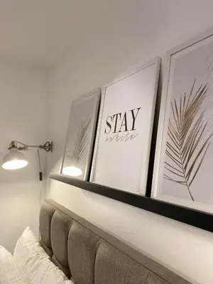 a shelf above a couch with four pictures on it at Womack Lodge in Saint Helens