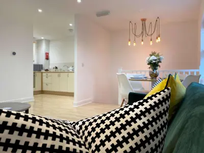a living room with a couch with checkered pillows at Womack Lodge in Saint Helens
