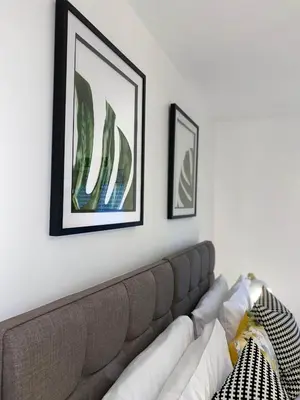 a living room with a couch and two pictures on the wall at Womack Lodge in Saint Helens