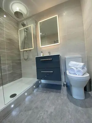 a bathroom with a sink and a toilet and a shower at Womack Lodge in Saint Helens