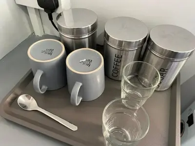 a tray with cups and a glass and a spoon at The Anfield Rooms in Liverpool