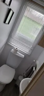 a bathroom with a white toilet and a window at Inside No. 9 Retreat in Carnforth