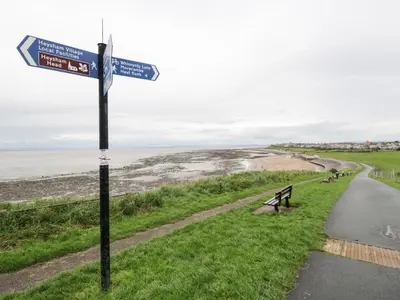 a street sign on the side of a road near the beach at Cosy Bee in Morecambe
