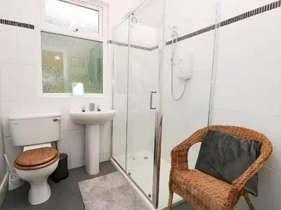 a bathroom with a toilet a sink and a shower at Cosy Bee in Morecambe