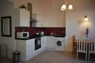 a kitchen with a washing machine and a microwave at Liverpool City Stays - Economy Room Close to city centre GG in Liverpool
