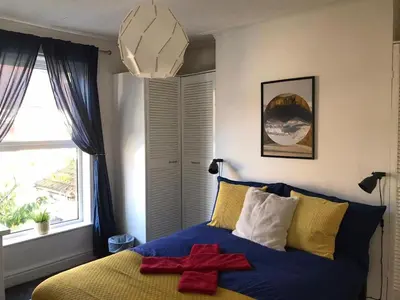 a bedroom with a bed with a red cross on it at Liverpool City Stays - Economy Room Close to city centre GG in Liverpool