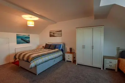 a small bedroom with a bed and a closet at The Place by the Sea in Blackpool