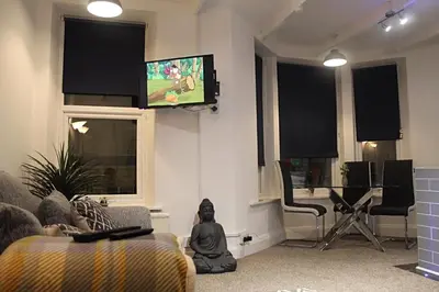 a living room with a flat screen tv on the wall at The Place by the Sea in Blackpool