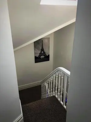 a staircase with a picture of the eiffel tower at The Place by the Sea in Blackpool