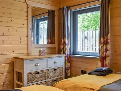 a bedroom with a bed and a mirror at Oak Lodge - Uk30005 in Lindal in Furness