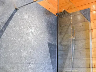 a shower in a bathroom with a concrete wall at Oak Lodge - Uk30005 in Lindal in Furness