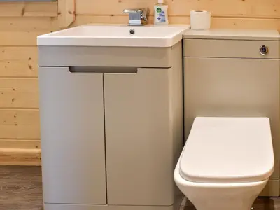 a bathroom with a white sink and a toilet at Oak Lodge - Uk30005 in Lindal in Furness