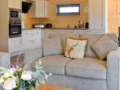 a couch with a dog pillow on it in a kitchen at Oak Lodge - Uk30005 in Lindal in Furness