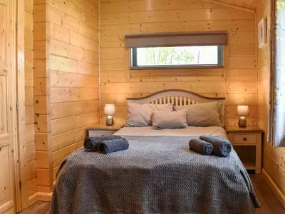 a bedroom with a bed with two pillows on it at Birch Lodge - Uk30006 in Lindal in Furness