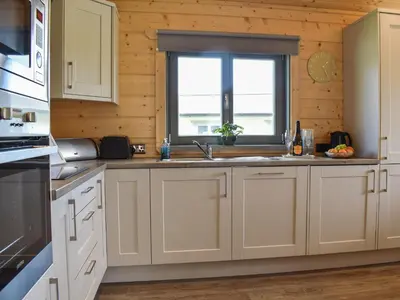 a kitchen with a sink and a window at Birch Lodge - Uk30006 in Lindal in Furness