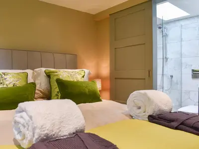 a bedroom with a bed with towels on it at The Bothy in Beetham