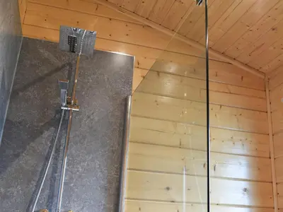 a shower in a room with a wooden ceiling at Pine Lodge - Uk30007 in Lindal in Furness