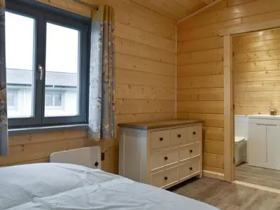 a bedroom with a bed and a sink and a window at Larch Lodge - Uk30009 in Lindal in Furness