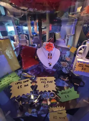 a room with signs on the floor with a toilet at Mardi Gras Hotel in Blackpool