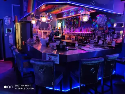 a bar in a restaurant with purple lights at Mardi Gras Hotel in Blackpool