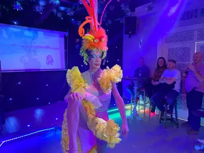 a woman in a costume on a stage at Mardi Gras Hotel in Blackpool