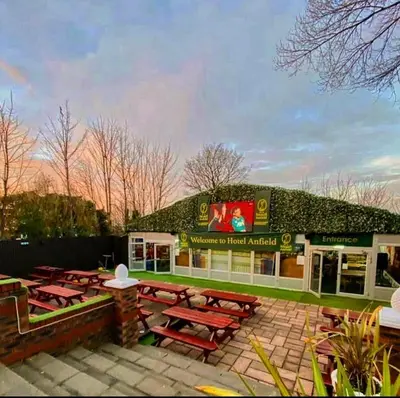 a restaurant with picnic tables in front of a building at Hotel Anfield in Liverpool