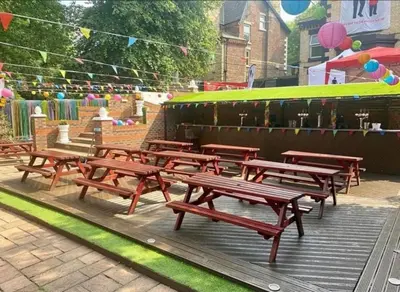 a group of wooden benches sitting in a park at Hotel Anfield in Liverpool