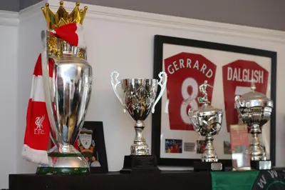 a group of trophies sitting on a table at Hotel Anfield in Liverpool