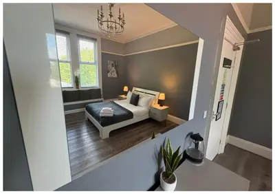 a small bedroom with a bed and a window at Hotel Anfield in Liverpool