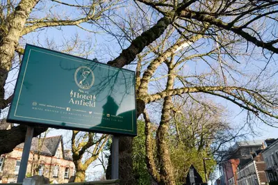 a sign in front of a tree at Hotel Anfield in Liverpool
