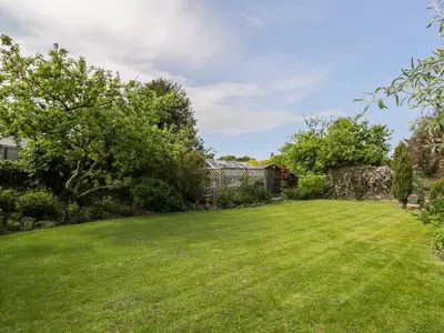 a large yard with a lawn and trees at The White House in Grange Over Sands