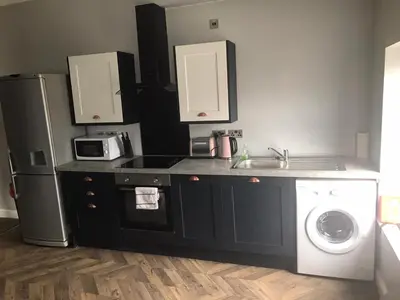 a kitchen with a sink and a washing machine at My Perfect Place Rooms & Apartments -Some rooms with Hot Tub- Free Parking in Blackpool
