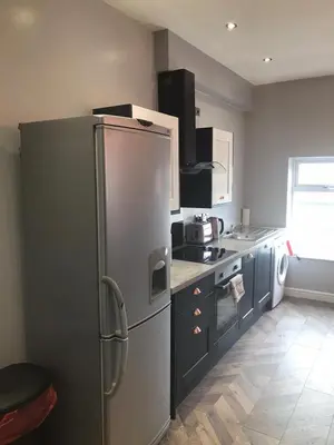 a kitchen with a large stainless steel refrigerator at My Perfect Place Rooms & Apartments -Some rooms with Hot Tub- Free Parking in Blackpool