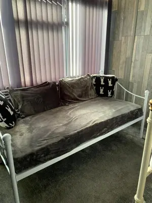 a couch in a room next to a window at My Perfect Place Rooms & Apartments -Some rooms with Hot Tub- Free Parking in Blackpool