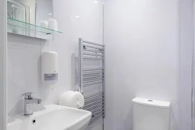 a white bathroom with a toilet and a sink at Hotel Santa Maria - formerly Daishs Blackpool in Blackpool