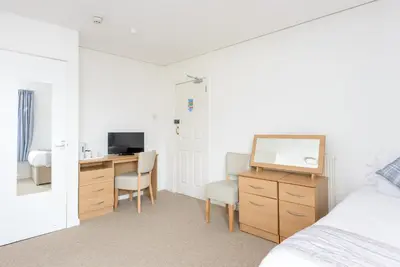 a bedroom with a desk with a computer and a bed at Hotel Santa Maria - formerly Daishs Blackpool in Blackpool