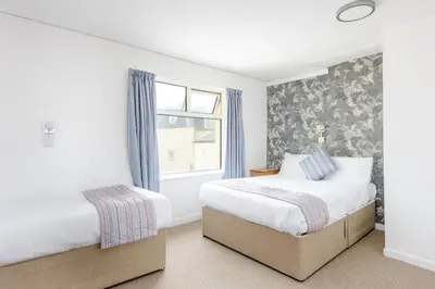 a bedroom with two beds and a window at Hotel Santa Maria - formerly Daishs Blackpool in Blackpool