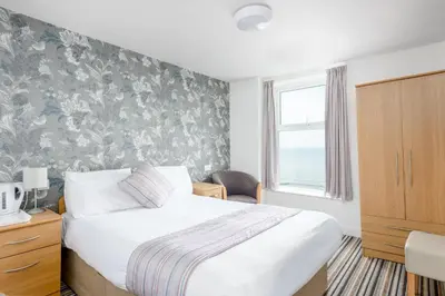 a hotel room with a bed and a window at Hotel Santa Maria - formerly Daishs Blackpool in Blackpool
