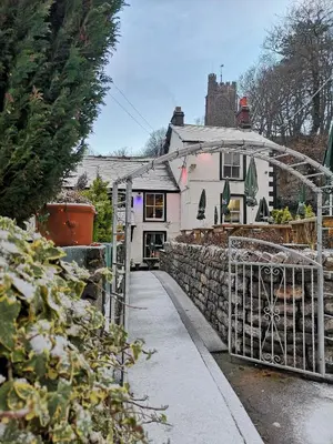 a house with a gate in front of a building at Brown Cow Apartment in Dalton in Furness