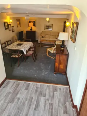 a living room with a table and a couch at Brown Cow Apartment in Dalton in Furness