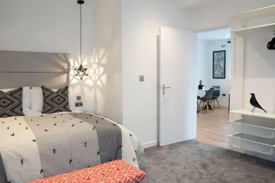 a bedroom with a bed and a dining room at Blackbird Luxury Apartments Room 5 in Blackpool