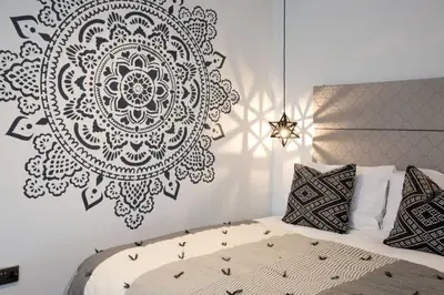 a bedroom with a black and white mandala on the wall at Blackbird Luxury Apartments Room 5 in Blackpool