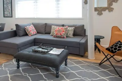 a living room with a couch and an ottoman at Blackbird Luxury Apartments Room 5 in Blackpool