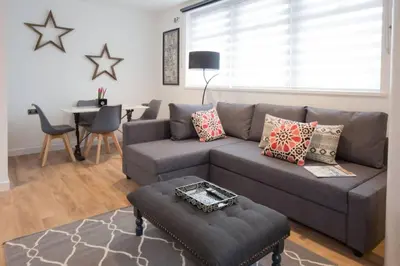 a living room with a gray couch and a table at Blackbird Luxury Apartments Room 5 in Blackpool