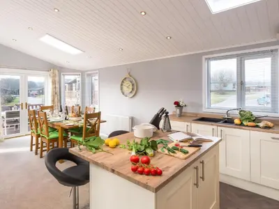 a kitchen with a counter with fruits and vegetables on it at Waternook Lodge in Carnforth