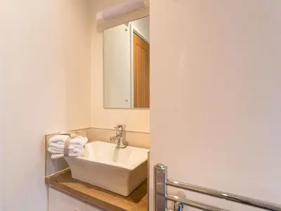 a bathroom with a sink and a mirror at Waternook Lodge in Carnforth