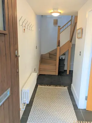 a hallway with a staircase and a stair case at Moss Tarn in Ulverston