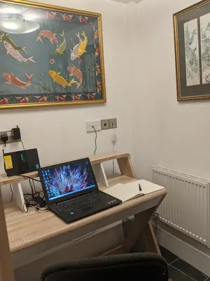 a laptop computer sitting on a wooden desk at Moss Tarn in Ulverston