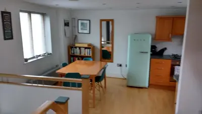 a kitchen with a table and a blue refrigerator at Moss Tarn in Ulverston